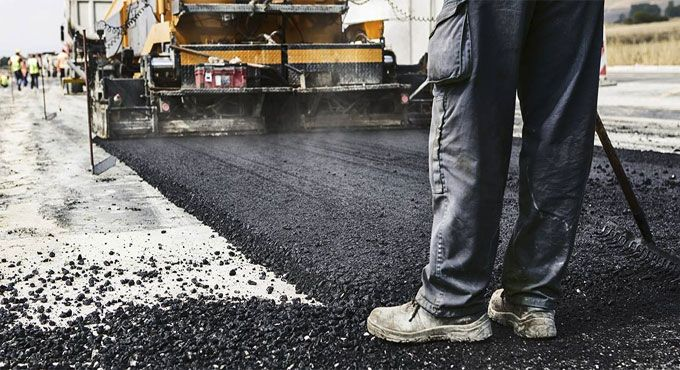 What is a bitumen road and how is it constructed?