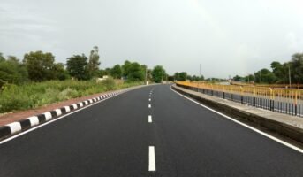How has National Highway-49 impacted the real estate sector?